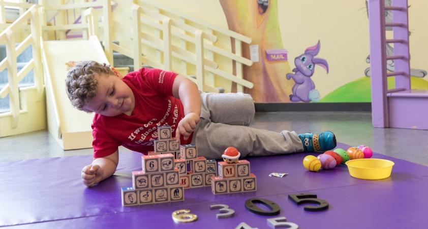 Little boy playing toy tains